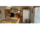 Open-concept kitchen and dining area with hardwood floors, wooden cabinetry, and ample natural light at 8107 Old London Rd, North Charleston, SC 29406