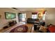 Well-lit living room with hardwood floors, dark leather furniture, and a large flat screen TV at 8107 Old London Rd, North Charleston, SC 29406