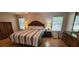 Inviting main bedroom features wood floors, soft lighting, and classic furnishings at 8107 Old London Rd, North Charleston, SC 29406