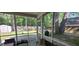 A relaxing screened-in porch with comfortable seating overlooking the backyard at 8107 Old London Rd, North Charleston, SC 29406