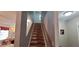 Carpeted stairway with natural wood steps and wood railing at 8107 Old London Rd, North Charleston, SC 29406
