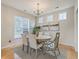 Elegant dining room with a round table, chandelier, and ample natural light at 83 Creekside Dr, Summerville, SC 29485