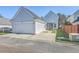 Two car garage with backyard, screened in porch, and partial fence view at 83 Creekside Dr, Summerville, SC 29485