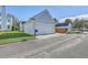 Two car garage with concrete driveway, lawn, and street view at 83 Creekside Dr, Summerville, SC 29485