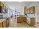 Functional kitchen features oak cabinets, laminate counters, and sleek black appliances at 83 Creekside Dr, Summerville, SC 29485