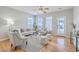 Light-filled living room features hardwood floors, ceiling fan and sliding door at 83 Creekside Dr, Summerville, SC 29485
