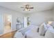 Main bedroom with ensuite bathroom features hardwood floors and ceiling fan at 83 Creekside Dr, Summerville, SC 29485