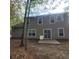 Picture of the rear exterior of the home with vinyl siding and sliding glass doors leading to the backyard at 9471 Netted Charm Ct, Ladson, SC 29456