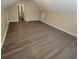 Spacious bonus room with laminate flooring, neutral paint, and open floor plan at 9471 Netted Charm Ct, Ladson, SC 29456