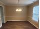 Dining room featuring wood floors, neutral walls, and a stylish chandelier, ideal for gatherings at 9471 Netted Charm Ct, Ladson, SC 29456