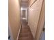 Hallway with modern wood flooring, recessed lighting, and closet space for storage at 9471 Netted Charm Ct, Ladson, SC 29456