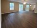 Spacious living room boasts wood floors, natural light from windows, and sliding glass door access to outdoors at 9471 Netted Charm Ct, Ladson, SC 29456