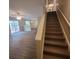 Open staircase in living room has modern wood flooring, which leads to the upper level at 9471 Netted Charm Ct, Ladson, SC 29456