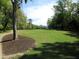 Expansive grassy backyard with mature trees, offering a serene and picturesque setting at 9677 Islesworth Way, Summerville, SC 29485
