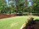 Well-maintained backyard with lush lawn, roses and decorative brown wood fence and black metal fence at 9677 Islesworth Way, Summerville, SC 29485