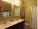 Bathroom featuring a double vanity with white countertops and a dark brown wood cabinet at 9677 Islesworth Way, Summerville, SC 29485