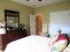 Bedroom with floral accents, a door leading to another room, and a spacious closet at 9677 Islesworth Way, Summerville, SC 29485