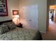 Bedroom featuring a patterned bed, a closet, and access to an adjacent room at 9677 Islesworth Way, Summerville, SC 29485