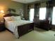 Comfortable bedroom with neutral walls, a decorative duvet cover, and dark wooden bedroom set at 9677 Islesworth Way, Summerville, SC 29485