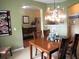 Elegant dining room with a decorative chandelier and views to the entryway and living area at 9677 Islesworth Way, Summerville, SC 29485