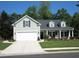 Charming home with a manicured lawn, a two-car garage and a welcoming front porch at 9677 Islesworth Way, Summerville, SC 29485