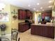 Well-lit kitchen featuring tile floors, wooden cabinets and modern appliances at 9677 Islesworth Way, Summerville, SC 29485