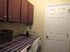 Laundry room features cabinets, washer and dryer, as well as an exterior door at 9677 Islesworth Way, Summerville, SC 29485