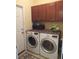 Laundry room includes cabinets, side-by-side LG washer and dryer, and decor at 9677 Islesworth Way, Summerville, SC 29485