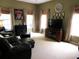 Cozy living room with carpet, windows, comfortable seating, and a TV at 9677 Islesworth Way, Summerville, SC 29485