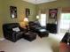 Comfortable living room with leather seating, natural light, and relaxed ambiance at 9677 Islesworth Way, Summerville, SC 29485