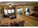 Open-concept living room with natural light, flowing into the kitchen and dining areas at 9677 Islesworth Way, Summerville, SC 29485