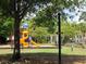 Vibrant playground with a colorful slide, set within a landscaped park area featuring white pergola at 9677 Islesworth Way, Summerville, SC 29485