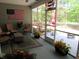 View of a screened porch features furniture, decor, potted plants, and a view of the outdoors at 9677 Islesworth Way, Summerville, SC 29485