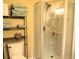 Shower stall with glass doors, showerhead, storage shelving, and shower products, with the toilet and towels nearby at 9677 Islesworth Way, Summerville, SC 29485
