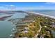Stunning aerial view of coastal property, highlighting location near Morris Island Lighthouse, ocean, and waterfront at 1214 Tabby Dr, Folly Beach, SC 29439