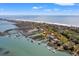 Picturesque aerial showcases homes along a shoreline, complete with docks extending into the tranquil waters at 1214 Tabby Dr, Folly Beach, SC 29439