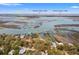 Stunning aerial view showcases waterfront property, nearby airport, and Charleston Peninsula at 1214 Tabby Dr, Folly Beach, SC 29439