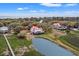 Breathtaking aerial view of a coastal home with red roof next to a lagoon with nearby ocean access at 1214 Tabby Dr, Folly Beach, SC 29439