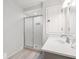 Well-lit bathroom features a modern vanity, a walk-in shower with sliding glass door at 1214 Tabby Dr, Folly Beach, SC 29439