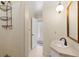 Well-lit bathroom with a shower, sink, and view of a hallway at 1214 Tabby Dr, Folly Beach, SC 29439