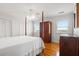 Bedroom featuring hardwood floors, a four-poster bed, and scenic window views at 1214 Tabby Dr, Folly Beach, SC 29439