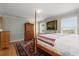 Bedroom featuring hardwood floors, green walls, an oriental rug, and a four-poster bed at 1214 Tabby Dr, Folly Beach, SC 29439