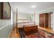 Cozy bedroom with a four-poster bed, hardwood floors, and area rug at 1214 Tabby Dr, Folly Beach, SC 29439