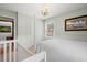 Cozy bedroom with a light green wall, four-poster bed, and white wainscoting at 1214 Tabby Dr, Folly Beach, SC 29439