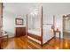 Bedroom with hardwood floors, four-poster bed, ceiling fan and double windows at 1214 Tabby Dr, Folly Beach, SC 29439