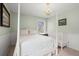 Bedroom featuring a four-poster bed, white wainscoting, and a small crib at 1214 Tabby Dr, Folly Beach, SC 29439