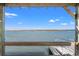 Wooden pier and view of the water from underneath a covered porch at 1214 Tabby Dr, Folly Beach, SC 29439