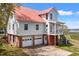 Stately exterior with a garage, a porch, and a driveway at 1214 Tabby Dr, Folly Beach, SC 29439