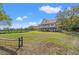 Two-story home with a metal roof, elevated design, and a sprawling green yard at 1214 Tabby Dr, Folly Beach, SC 29439