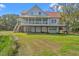 Lovely home with a garage and porch, complemented by an expansive front yard at 1214 Tabby Dr, Folly Beach, SC 29439